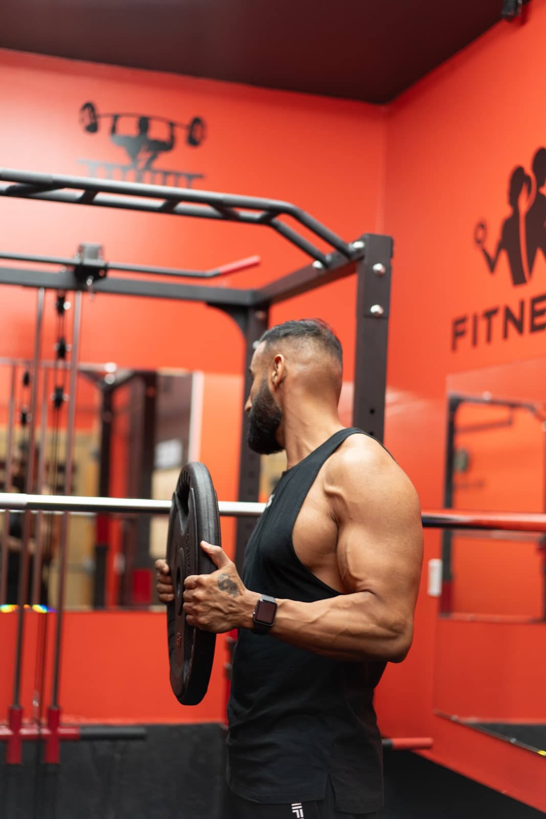 Sunil loading a plate in the private training space